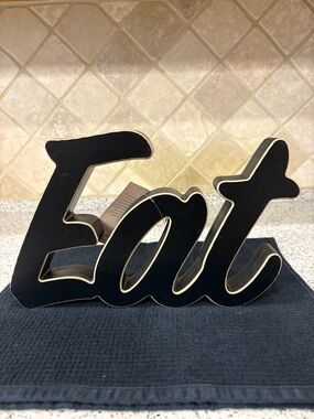 Black “EAT" Wall Sign